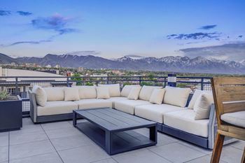 Rooftop lounge with views of mountains and city skyline